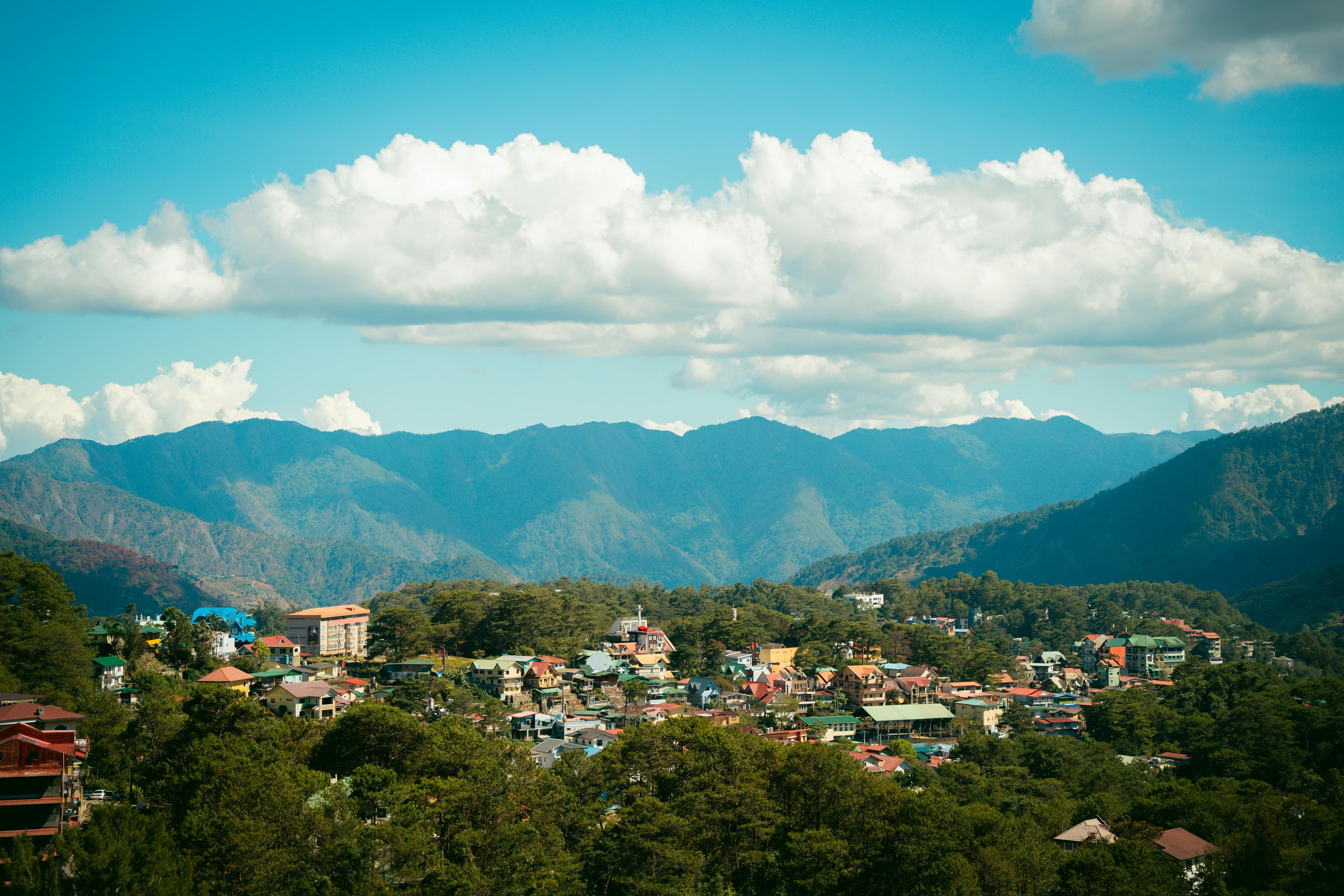 Panoramic landscape of Baguio City's mountain scenery with lush green hills and cool misty atmosphere in the Philippines
