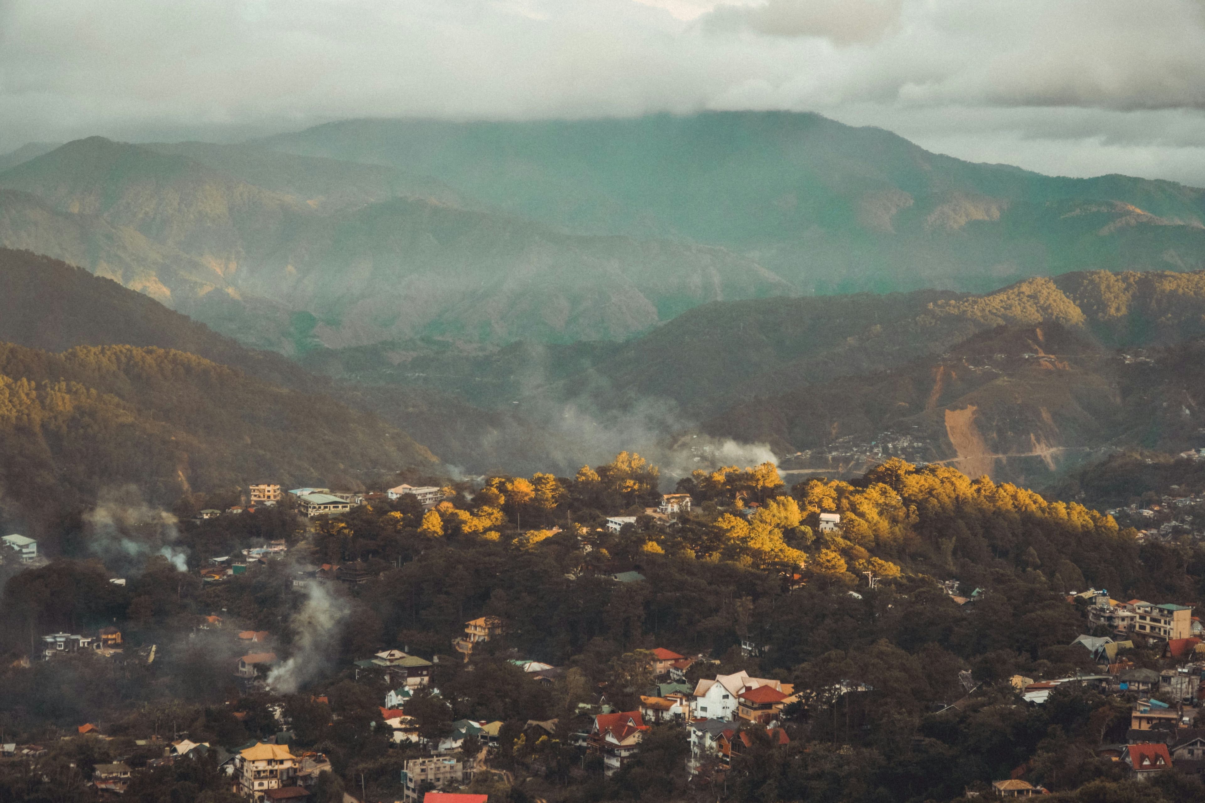 Panoramic landscape of Baguio City's mountain scenery with lush green hills and cool misty atmosphere in the Philippines